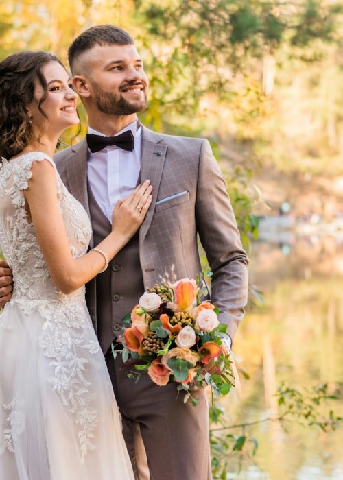 man in gray suit and woman in white wedding dress