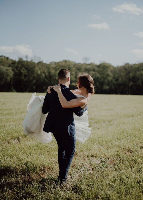 man carrying woman during daytime